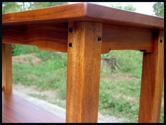 Detail of the square Ebony pegs and the carved "cloud-lift" stretchers supporting the table top.